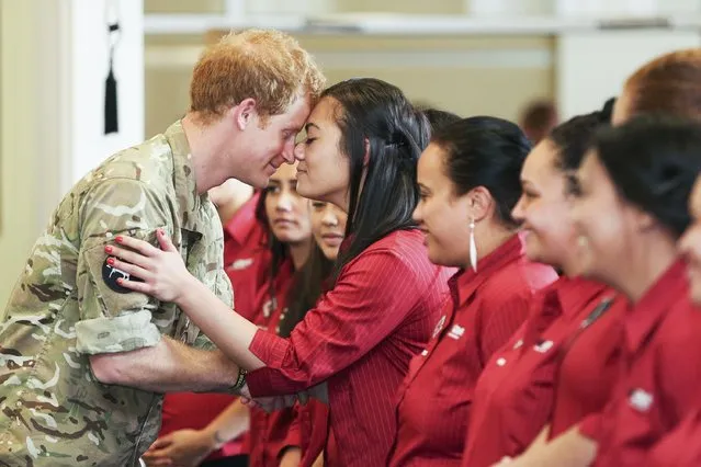 Britain's Prince Harry (L) receives a “hongi”, traditional Maori greeting, from a member of the Kairanga Kapa Haka group during a visit to Linton Military Camp in Linton, near Palmerston North, on May 13, 2015. Prince Harry arrived in New Zealand on May 9 for a week-long visit. (Photo by Hagen Hopkins/AFP Photo)