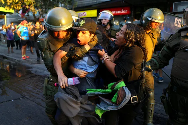 A protester is detained during a rally marking the anniversary of the death of union leader Juan Pablo Jimenez, in Santiago, Chile February 21, 2017. (Photo by Ivan Alvarado/Reuters)