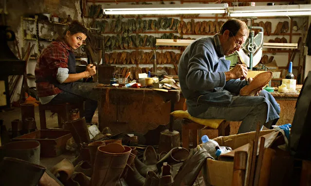 Step by step, Portugal. The photographer writes: “I was surprised when I saw this old shoemakers with two workers, one of them a young woman doing a job usually done by older men. The look in her eyes is as strong and heavy as her work”. (Photo by João Borges/Smithsonian Photo Contest)