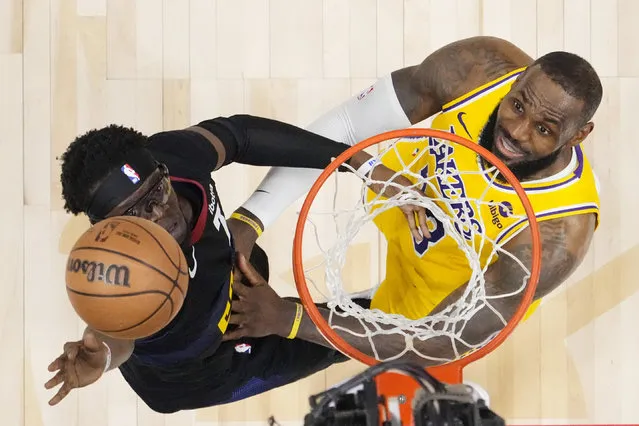 Denver Nuggets guard Reggie Jackson (7) and Los Angeles Lakers forward LeBron James (23) eye the ball during the second half in Game 2 of an NBA basketball first-round playoff series, Monday, April 22, 2024, in Denver. (Photo by Jack Dempsey/AP Photo)