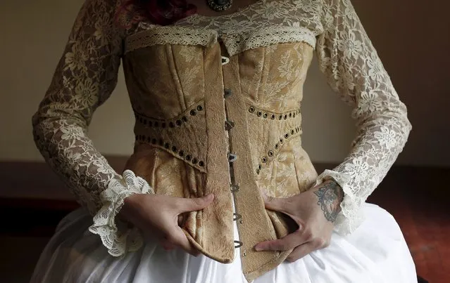 Adriana Barahona, known as " Madame Barocle," adjusts her corset at her house in Heredia, Costa Rica June 4, 2015. Barahona says she has been passionate about clothing from the era of Britain's Queen Victoria (1837-1901), and has been making and wearing them since the age of 15. REUTERS/Juan Carlos Ulate