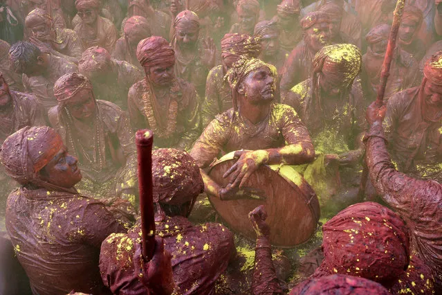 Indian Hindu devotees celebrate Holi, the spring festival of colours, during a traditional gathering at Nandgaon village in Uttar Pradesh state on March 7, 2017. (Photo by AFP Photo/Stringer)