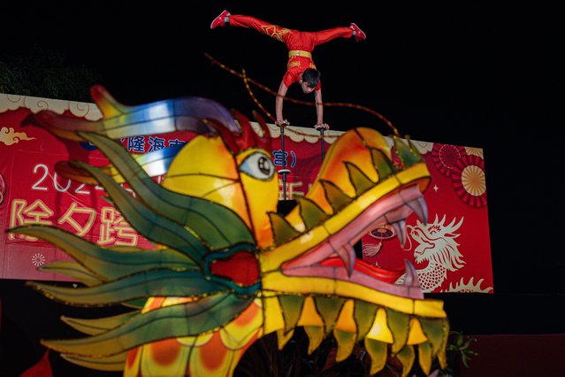 A member of a China Acrobatics troupe performs during the Lunar New Year celebration at Thean Hou Temple on February 10, 2024, in Kuala Lumpur, Malaysia. Chinese New Year in Malaysia is marked by family gatherings, festive adornments and traditional rituals embodying a spirit of hope and renewal for the year ahead, and aims to bring joy and prosperity to all while fostering a sense of unity and hope for a successful Year of the Dragon. (Photo by Annice Lyn/Getty Images)