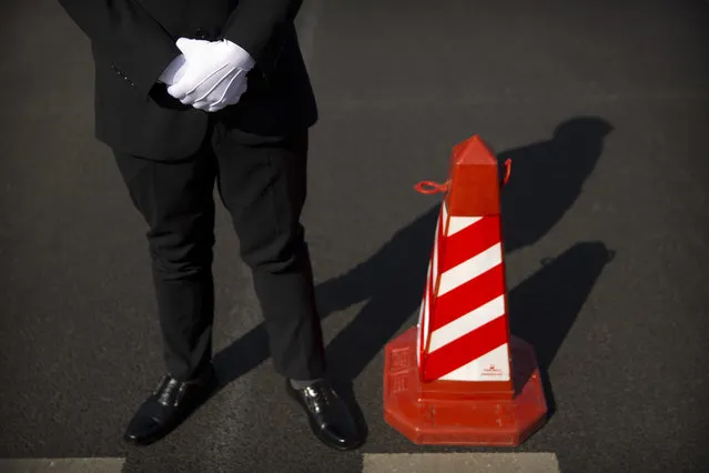 In this Wednesday, March 8, 2017 photo, a security official stands next to a traffic cone as he guards a crosswalk outside of the Great Hall of the People before a plenary session of China's National People's Congress (NPC) in Beijing. (Photo by Mark Schiefelbein/AP Photo)