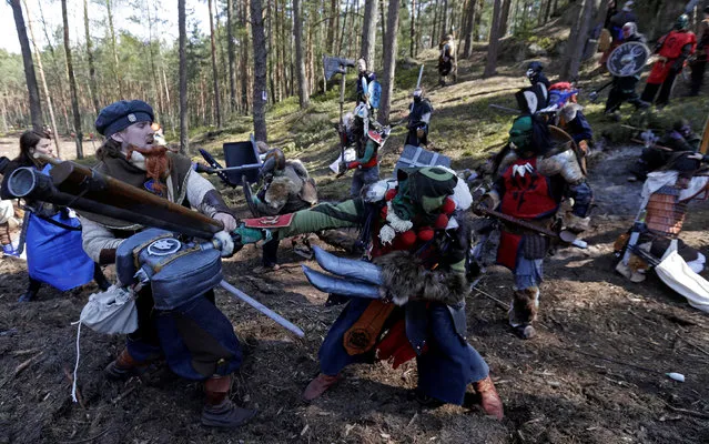 People dressed as characters from the computer game “World of Warcraft” fight during a battle near the village of Sosnova, Czech Republic, April 30, 2016. (Photo by David W. Cerny/Reuters)
