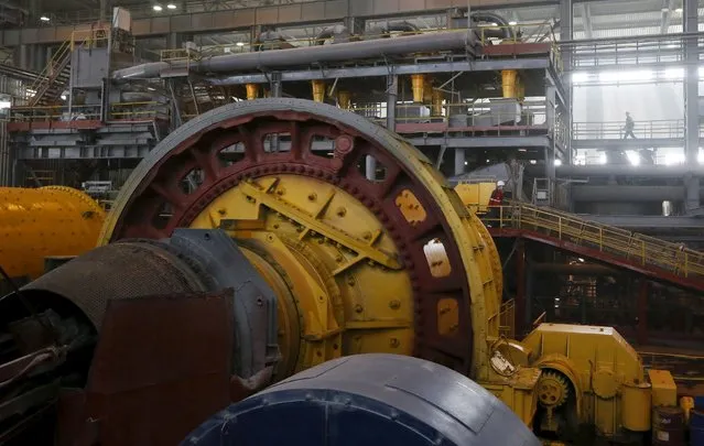 Employees walk near rotating crusher equipment inside a gold procession plant at the Olimpiada gold operation, owned by Polyus Gold International company, in Krasnoyarsk region, Eastern Siberia, Russia, June 30, 2015. (Photo by Ilya Naymushin/Reuters)