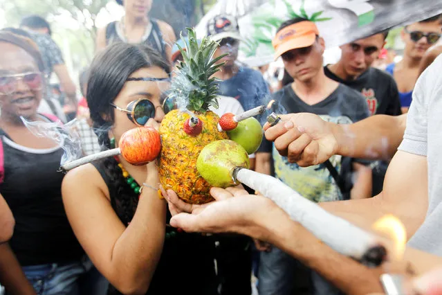 A woman smokes marijuana during a global March for marijuana in Medellin, Colombia, May 7, 2016. (Photo by Fredy Builes/Reuters)