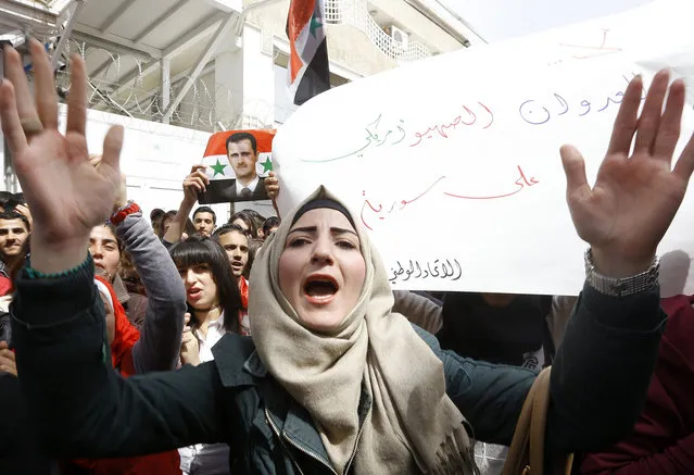 A Syrian woman shouts slogans during a demonstration outside the United Nation's (UN) office in the capital Damascus, on April 11, 2017, in support of their country's President Bashar al-Assad. Hundreds of Syrian students gathered outside the United Nations headquarters in Damascus to protest last week's American strike on a government air base. (Photo by Louai Beshara/AFP Photo)