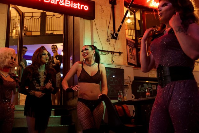 Transgender woman Daniella Milla Tokodi smiles during a drag queen show at a bar in Budapest, Hungary, June 12, 2021. Assigned male at birth, the 31-year-old said after having an operation in 2018 to complete her gender transition she broke into tears when she saw herself in the mirror and that she felt “whole”. “It was a relief ... Since then I am able to look into people's eyes. I can communicate with people, I feel whole”. That feeling is now overshadowed by worry over a string of laws passed by Prime Minister Viktor Orban's right-wing government that critics say undermine LGBTQ rights, with the latest this week that bans the “display and promotion” of homosexuality and gender change among under-18s, in schools and in the media. (Photo by Bernadett Szabo/Reuters)