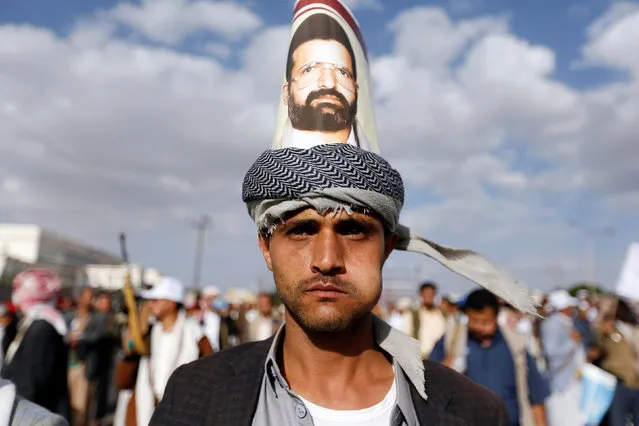 A Houthi follower sports a poster of the Houthi movement's founder, Houssein Badruddin al-Houthi, during a demonstration against the U.S. intervention in Yemen, in the country's capital Sanaa, May 13, 2016. (Photo by Khaled Abdullah/Reuters)