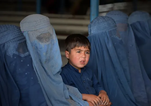 Afghan refugee families wait to be registered at the United Nations High Commissioner for Refugees (UNHCR) repatriation centre on the outskirts of Peshawar on April 27, 2017, as they prepare to return to their home country after fleeing civil war and Taliban rule. Pakistan resumed its mass repatriation of Afghan refugees despite past accusations of coercion in the supposedly voluntary UN programme to return hundreds of thousands to a war-torn nation. (Photo by Abdul Majeed/AFP Photo)