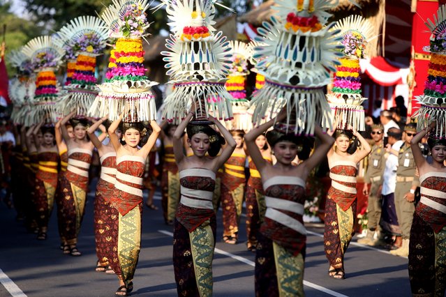 Women in traditional costume carry offerings during a parade at the opening of the Bali arts festival in Denpasar, Bali, Indonesia on Saturday, June 15, 2024. (Photo by Firdia Lisnawati/AP Photo)