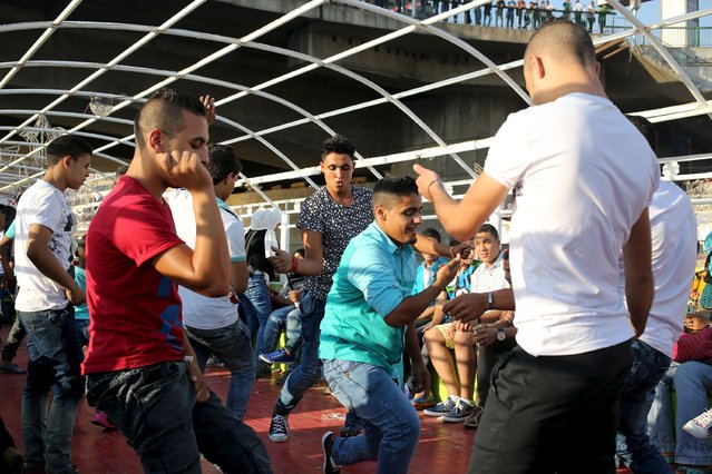 Young people dance during a Nile cruise during celebrations for Eid, which marks the end of the holy fasting month of Ramadan, in Cairo, Egypt, July 17, 2015. (Photo by Asmaa Waguih/Reuters)