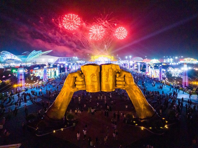 Fireworks light up the night sky over a sculpture featuring two hands holding beer glasses at the Golden Sand Beach during the carnival night of the 34th Qingdao International Beer Festival on August 11, 2024 in Qingdao, Shandong Province of China. The 34th Qingdao International Beer Festival on August 11. (Photo by Yang Xuemei/VCG via Getty Images)