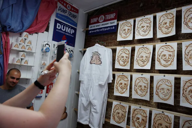 A woman uses her phone to photograph portraits of U.S. Republican presidential candidate Donald Trump made partially from dog feces that had been collected from in front of Trump Tower in New York, U.S., June 4, 2016. (Photo by Lucas Jackson/Reuters)