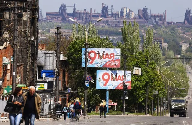 Victory Day banners are seen in a street on the 77th anniversary of the victory over Nazi Germany in World War II in Mariupol, Donetsk Region, Ukraine on May 9, 2022. (Photo by Peter Kovalev/TASS)