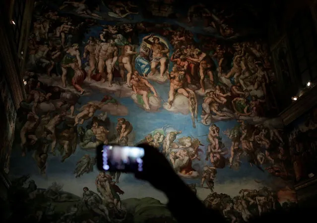 A visitor takes pictures with his cellphone at a full-size replica of the Sistine Chapel after the opening ceremony in Mexico City, Mexico June 7, 2016. (Photo by Henry Romero/Reuters)