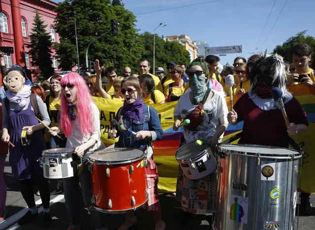 Ukrainian gay rights activists take part in a march in Kiev, Ukraine, Sunday, June 12, 2016. (Photo by Sergei Chuzavkov/AP Photo)