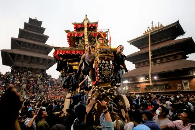 The chariot of God Bhairab is pulled through the city center during the Biska festival in Bhaktapur, Nepal on April 10, 2022. (Photo by Navesh Chitrakar/Reuters)