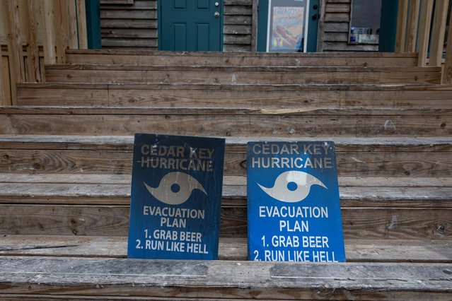 Signs are seen at the entrance to a business as Hurricane Helene intensifies before its expected landfall on Florida’s Big Bend, in Cedar Key, Florida on September 25, 2024. (Photo by Marco Bello/Reuters)