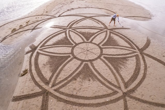 A drone view shows artist Nikola Faler working on sand drawing in the mouth of the river Neretva during the 4th Sand Art Festival near Ploce, Croatia, on September 14, 2024. (Photo by Antonio Bronic/Reuters)