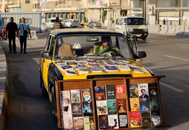 Mohamed Azzam, a taxi driver in Egypt’s coastal city of Alexandria who turned his car into a mobile library for exchanging and selling school books and novels, sits inside his taxi, in Alexandria, Egypt on June 3, 2024. (Photo by Mohamed Abd El Ghany/Reuters)