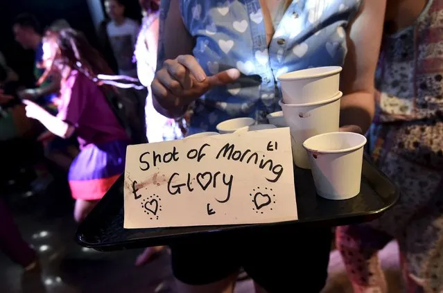 A woman sells a natural stimulant organic drink at “Morning Gloryville” at the Ministry of Sound in south London August 11, 2015. (Photo by Toby Melville/Reuters)