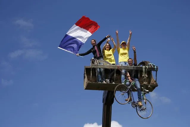 Cycling, Tour de France cycling race, The 188-km (117 miles) 1st stage from Mont Saint-Michel to Utah Beach Sainte-Marie-du-Mont, France on July 2, 2016. Fans hold a French flag during the race. (Photo by Juan Medina/Reuters)