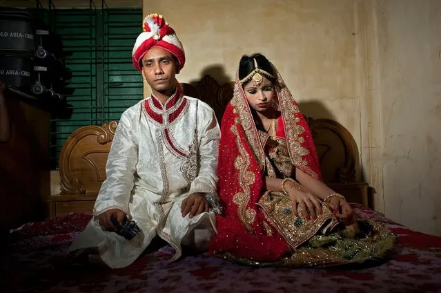 Mohammad Hasamur Rahman, 32, poses for photographs with his new bride, 15-year-old Nasoin Akhter, August 20, 2015, in Manikganj, Bangladesh. (Photo by Allison Joyce/Getty Images)