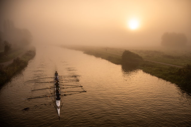 Rowers set out on the river Cam in Cambridge, UK on October 18, 2024 as dawn breaks through a wall of fog. (Photo by James Linsell Clark/South West News Service)