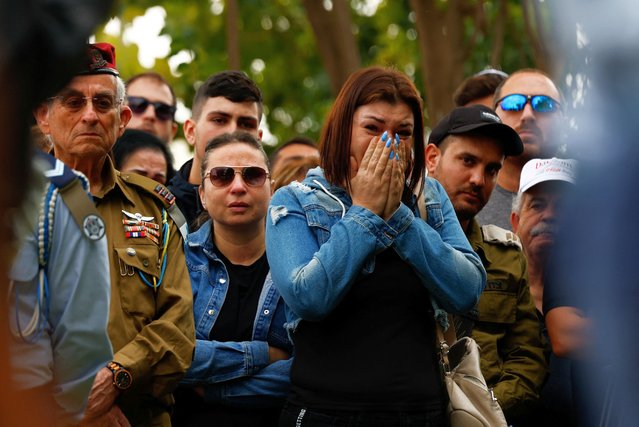A woman reacts as friends and family mourn Master sergeant (reserves) Sergey Shmerkin, 32, who was killed in the northern Gaza Strip amid the ongoing ground operation of the Israeli army against Palestinian Islamist group Hamas, at his funeral in Kiryat Shmona, northern Israel on November 13, 2023. (Photo by Evelyn Hockstein/Reuters)