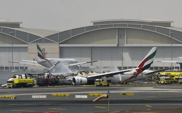 The damaged Boeing 777 of Emirates airlines on the tarmac of Dubai International Airport, on Wednesday, August 3, 2016. The plane, on its way from India to Dubai, crashed landed at the airport. Miraculously, all the 300 passengers and crew of the ill-fated plane are reported safe. A crew member of the emergency response team, however, lost his life fighting the blaze. (Photo by Ahmed Ramzan/AFP Photo/Gulf News Dubai)
