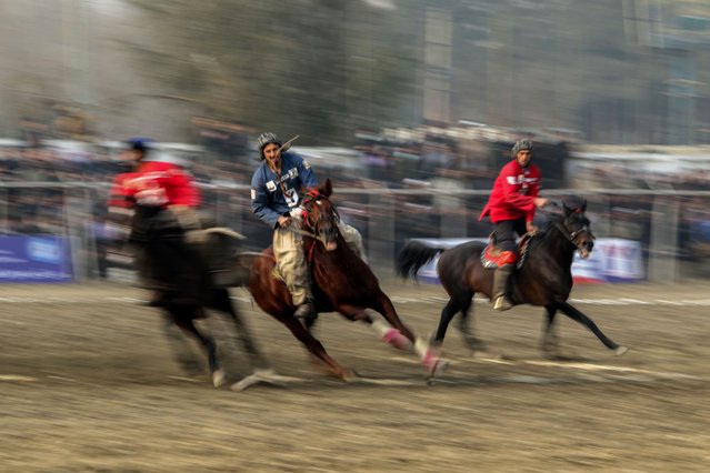 Horsemen from Sar-e-Pol (blue) and Badakshan (Red) provincial teams play Buzkashi at the opening of the sixth season of the Afghan Buzkashi Premier League in Kabul, Afghanistan, 11 December 2024. The sixth season of the Afghan Buzkashi Premier League has officially commenced in Kabul, featuring 11 competing teams over a ten-day period at the Buzkashi Field in the Yeketoot area. This year's tournament includes players from Tajikistan and Kazakhstan, with each team permitted to field two foreign players. Participating teams hail from various provinces, including Sar-e-Pul, Takhar, Herat, and others.Buzkashi is a traditional sport in which horse-mounted players attempt to place a goat or calf carcass in a goal. (Photo by Samiullah Popal/EPA/EFE)