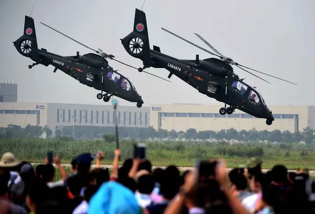 Gunships perform at the opening ceremony of the Tianjin International Helicopter Exhibition in a helicopter base of Aviation Industry Corporation of China in the Airport Area of China Pilot Free Trade Zone of Tianjin, north China, north China, September 9, 2015. The exhibition displayed 56 helicopters and attracted 366 enterprises. (Photo by Zhang Chenlin/Xinhua/Sipa USA)