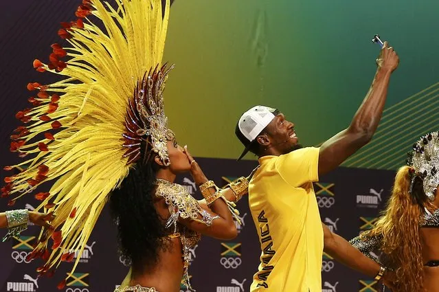 Jamaican track star Usain Bolt with Brazilian samba dancers at a press conference, August 8, 2016, Rio de Janeiro, Brazil. (Photo by Nacho Doce/Reuters)