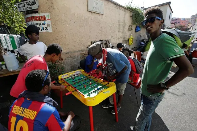 Migrants play table football at a makeshift camp in Via Cupa (Gloomy Street) in downtown Rome, Italy, August 1, 2016. (Photo by Max Rossi/Reuters)