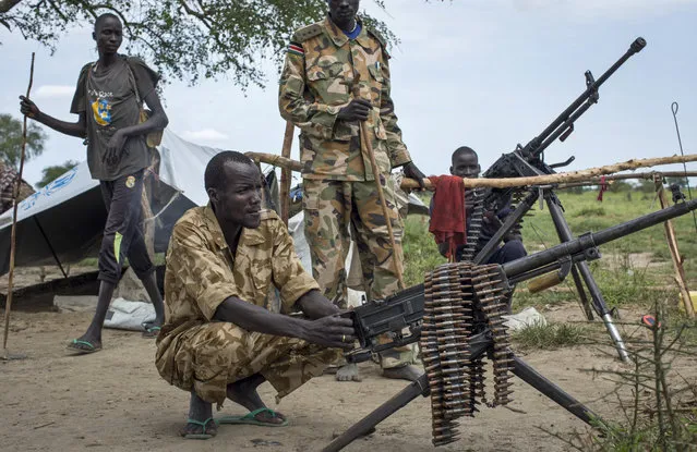 Rebel soldiers guard the village of Majieng, about 6km from the town of Bentiu, in South Sudan Saturday, September 20, 2014. Seyoum Mesfin, the chairman of the South Sudan mediation process said Saturday there is renewed fighting in South Sudan between government and rebel troops and that it is a purposeful act aimed at derailing the next phase of the peace process. (Photo by Matthew Abbott/AP Photo)