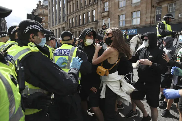Protesters arrive in George Square for a “Glasgow Says No to Racism” demonstration, in Glasgow city centre, Scotland, Saturday, June 20, 2020. The event was held as a stand against racism on World Refugee Day. (Photo by Andrew Milligan/PA Wire via AP Photo)