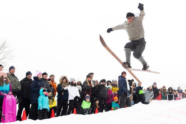 A participant jumps on vintage skis during a historical ski race in the northern Bohemian town of Smrzovka, Czech Republic, on February 15, 2025. (Photo by Eva Korinkova/Reuters)