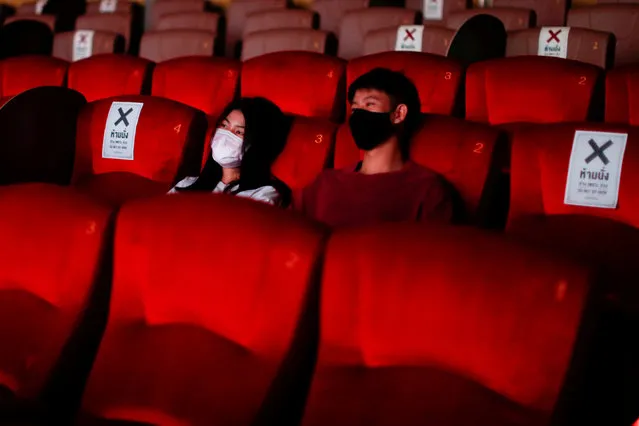 People wearing protective face masks are seen inside a movie theater during its reopening after the Thai government eased isolation measures to prevent the spread of the coronavirus disease (COVID-19) in Bangkok, Thailand, June 1, 2020. (Photo by Jorge Silva/Reuters)