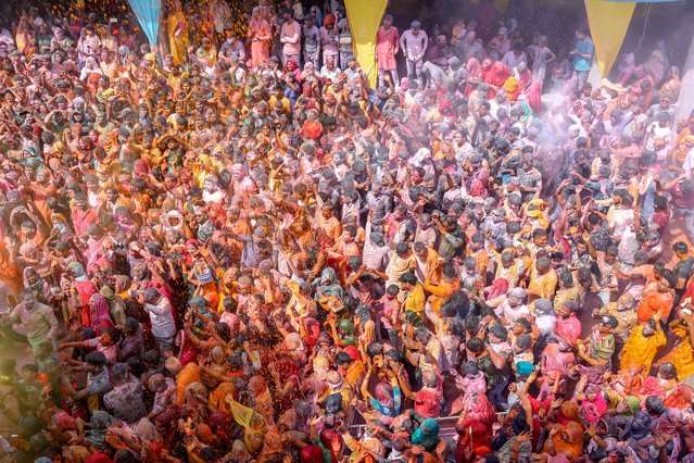 Hindu devotees diffuse flowers and 'Gulal', a coloured powder, during the Holi celebrations, the Hindu spring festival of colours, in Vrindavan, in India's northern state of Uttar Pradesh on March 13, 2025. (Photo by AFP Photo)