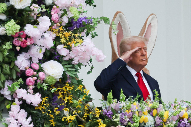 President Donald Trump salutes as he attends the annual White House Easter Egg Roll, on April 21, 2025. (Photo by Leah Millis/Reuters)