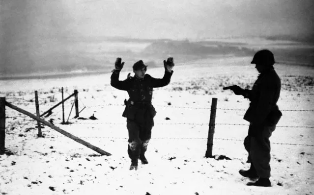 A German surrenders during the Third Army drive in Bastogne, Luxembourg, on January 12, 1945, to relieve U.S. troops encircled there. (Photo by AP Photo)