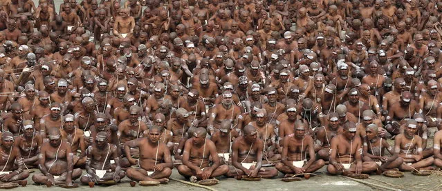 Hindu holy men of the Juna Akhara sect participate in a rituals that are believed to rid them of all ties in this life and dedicate themselves to serving God as a “Naga” or naked holy men, at Sangam, the confluence of the Ganges and Yamuna River during the Maha Kumbh festival in Allahabad, India, Wednesday, February 6, 2013. The significance of nakedness is that they will not have any worldly ties to material belongings, even something as simple as clothes. This ritual that transforms selected holy men to Naga can only be done at the Kumbh festival.(Photo by Manish Swarup/AP Photo)