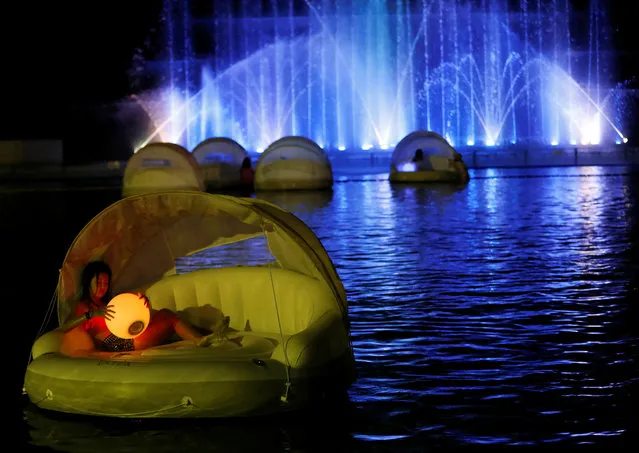 Visitors enjoy a swimming pool at night, amid the coronavirus disease (COVID-19) outbreak, at Toshimaen amusement park which will close 94 years after it first opened with part of the site to be turned into a new Harry Potter theme park in 2023, in Tokyo, Japan on August 21, 2020. (Photo by Issei Kato/Reuters)