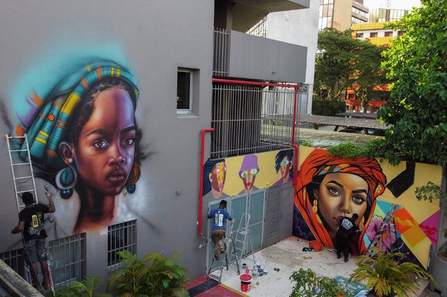 Artists who came to participate in the first edition of Graff Ivoire, create graffiti and murals on the facade of Ibis hotel in Abidjan, Ivory Coast on November 15, 2024. (Photo by Luc Gnago/Reuters)
