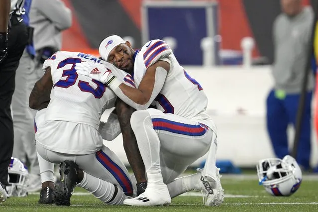 Buffalo Bills' Siran Neal (33) and Nyheim Hines react after teammate Damar Hamlin was injured during the first half of an NFL football game against the Cincinnati Bengals, Monday, January 2, 2023, in Cincinnati. (Photo by Jeff Dean/AP Photo)