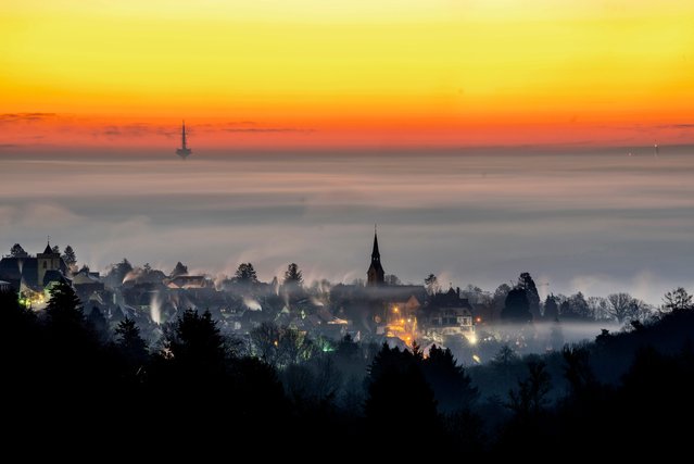 Fog covers the city of Kronberg near Frankfurt in the background, Germany, early Saturday, December 28, 2024. (Photo by Michael Probst/AP Photo)