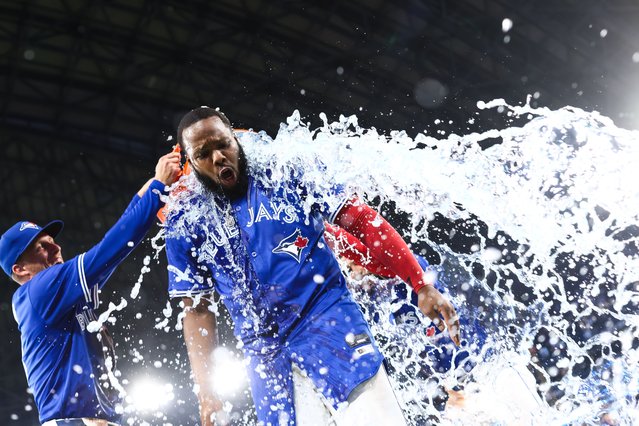 Vladimir Guerrero Jr. #27 of the Toronto Blue Jays gets an ice bath from Myles Straw #3 after their MLB game against the New York Yankees at Rogers Centre on June 30, 2025 in Toronto, Ontario, Canada. (Photo by Cole Burston/Getty Images)