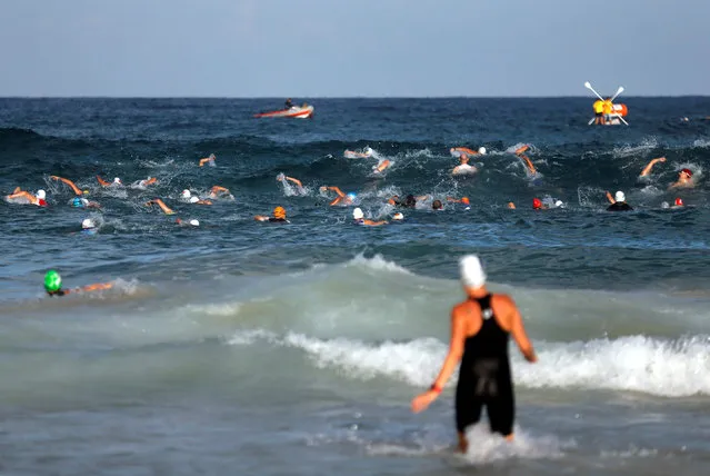 Participants swim in the Mediterranean Sea as they take part in a triathlon in Ashdod, Israel September 23, 2016. (Photo by Amir Cohen/Reuters)